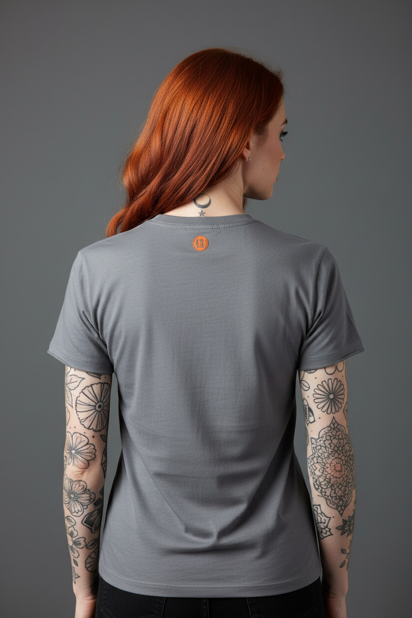 Back view of tattooed red-headed woman wearing t-shirt showing neck logo