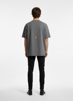 Model with back to camera wearing gray t-shirt